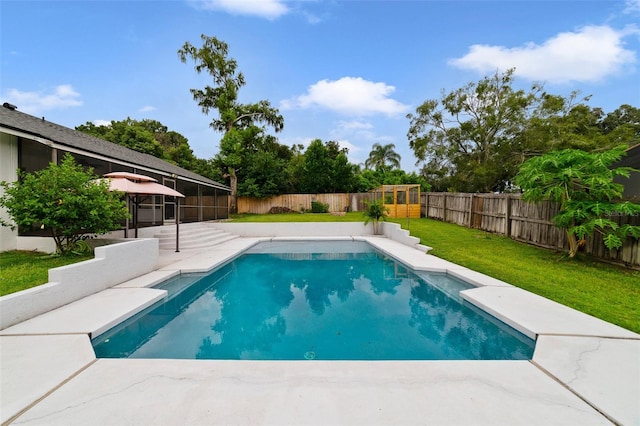 view of pool featuring a lawn and a patio