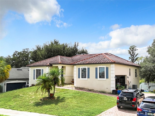 mediterranean / spanish home featuring a front yard