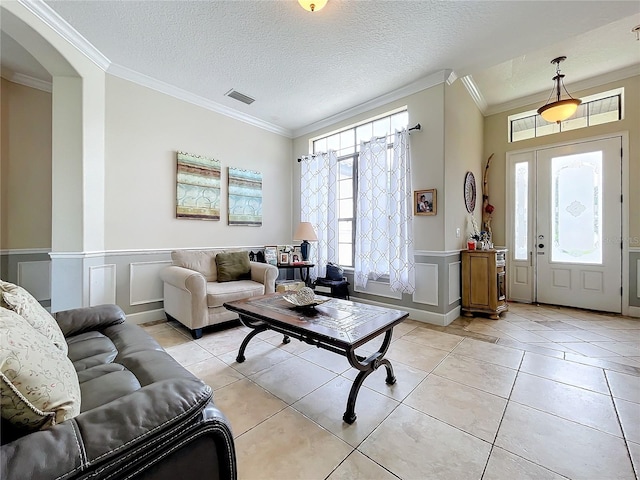 living room with ornamental molding and a wealth of natural light