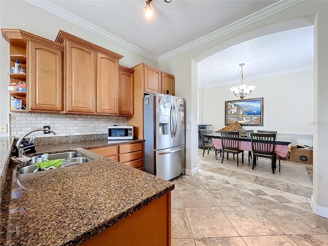 kitchen featuring appliances with stainless steel finishes, light tile patterned floors, crown molding, an inviting chandelier, and sink