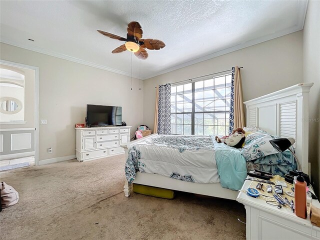 bedroom featuring carpet floors, crown molding, a textured ceiling, and ceiling fan