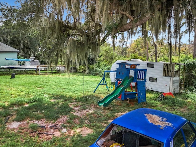 view of jungle gym with a yard and a water view