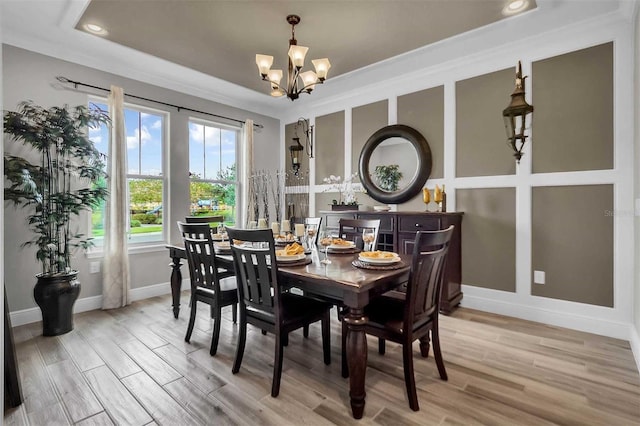 dining area featuring baseboards, recessed lighting, wood finished floors, and an inviting chandelier