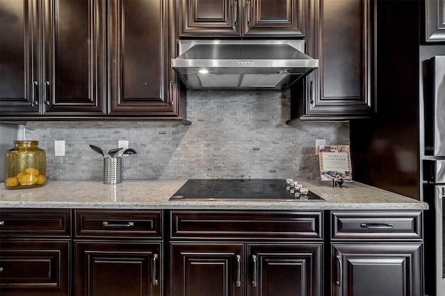 kitchen featuring decorative backsplash, black electric stovetop, dark brown cabinets, and ventilation hood