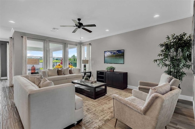 living area featuring wood finished floors, visible vents, and baseboards