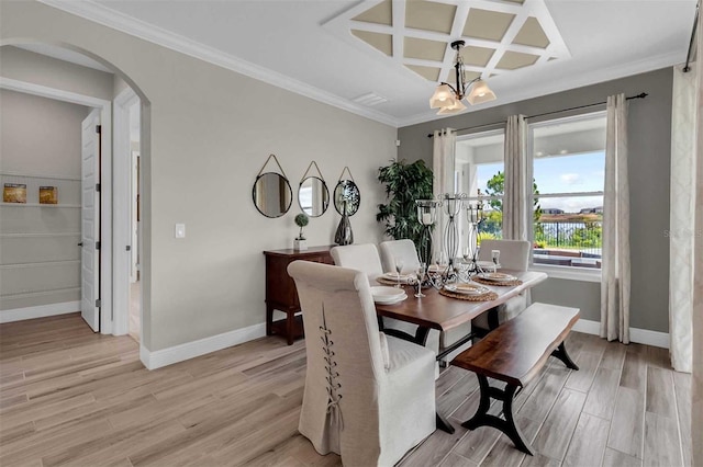 dining area featuring light wood-type flooring, baseboards, arched walkways, and coffered ceiling