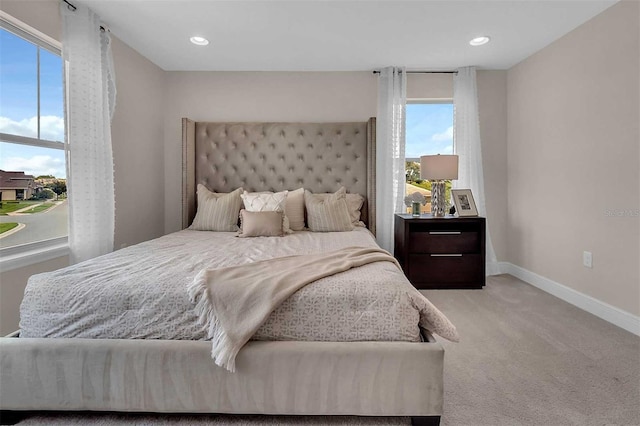 carpeted bedroom featuring baseboards and recessed lighting