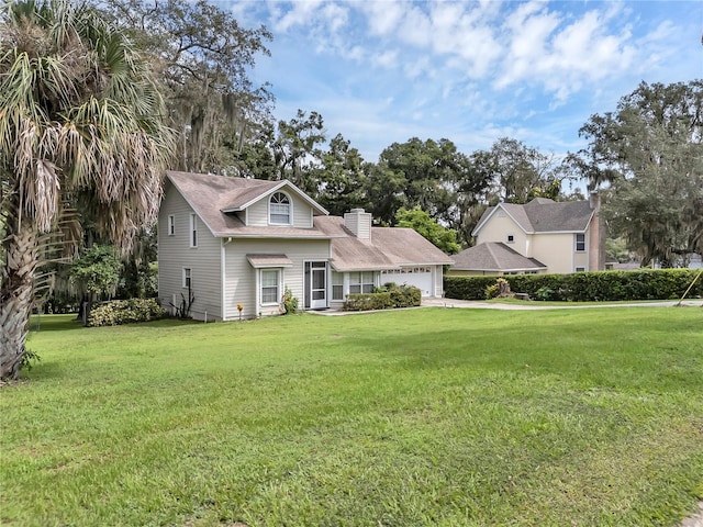 view of front of house featuring a garage and a front lawn