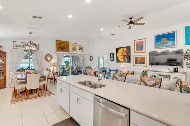 kitchen with dishwasher, white cabinets, ceiling fan with notable chandelier, sink, and hanging light fixtures