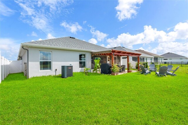 rear view of house with a pergola, a yard, and cooling unit