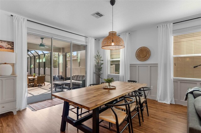 dining space featuring light wood-type flooring and ceiling fan