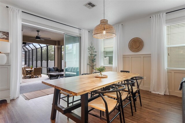 dining room with a wealth of natural light, ceiling fan, and hardwood / wood-style flooring