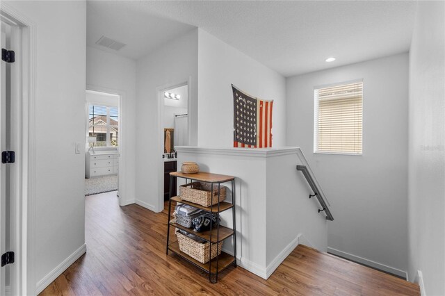 corridor with hardwood / wood-style floors