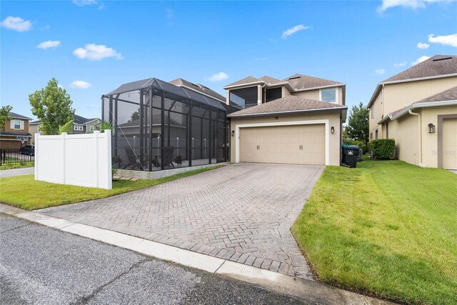 view of front of house featuring glass enclosure, a front lawn, and a garage