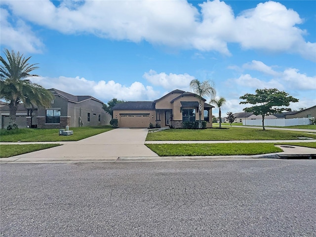 view of front of property with a garage and a front lawn