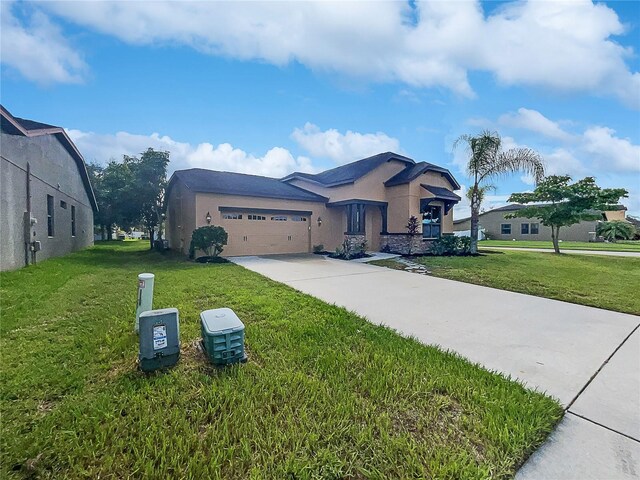 view of front of property featuring a garage and a front lawn