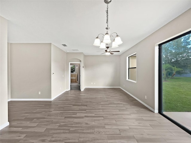 unfurnished dining area featuring light hardwood / wood-style flooring and ceiling fan with notable chandelier