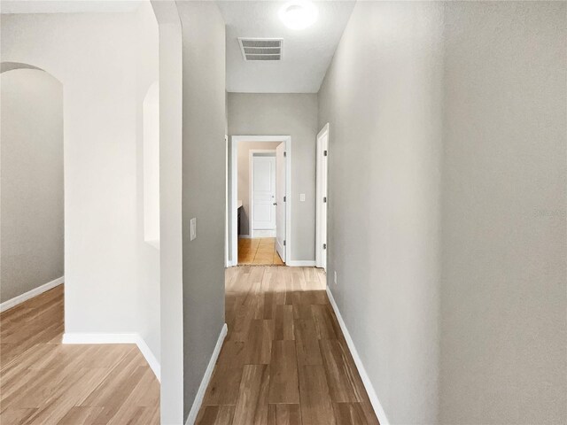 hallway with hardwood / wood-style floors