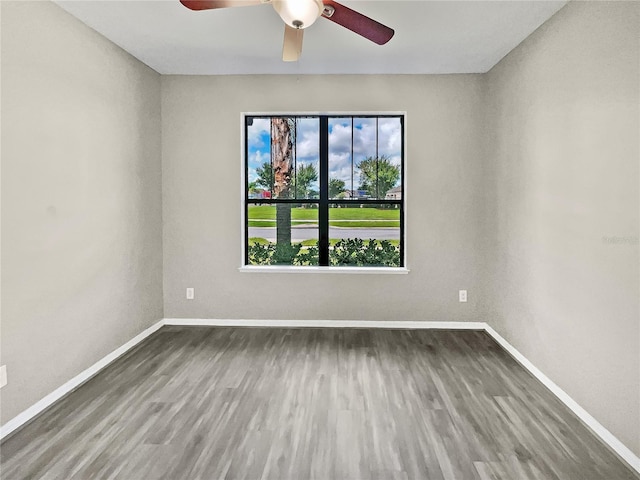 spare room with ceiling fan and dark hardwood / wood-style floors