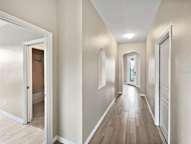 corridor with light hardwood / wood-style flooring