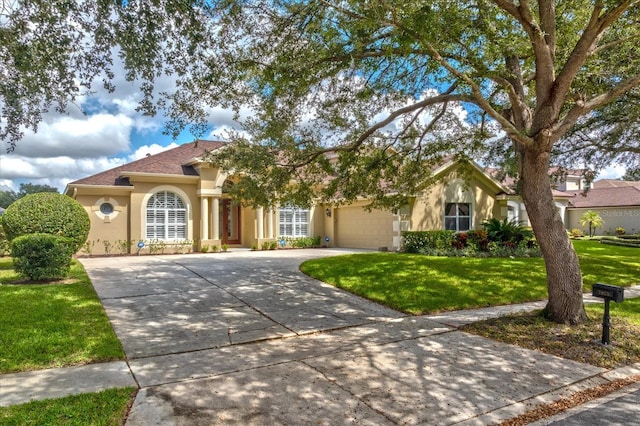 view of front of home featuring a front yard and a garage