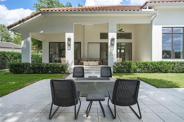 back of house featuring an outdoor living space, a yard, and a patio area