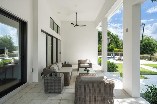 view of patio featuring an outdoor living space, a fenced in pool, and ceiling fan