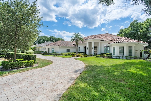 mediterranean / spanish-style house featuring a front lawn