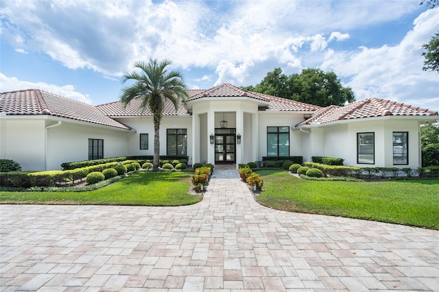 mediterranean / spanish house with a front lawn