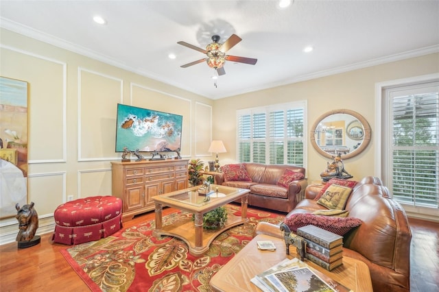 living room with ceiling fan, hardwood / wood-style flooring, and crown molding