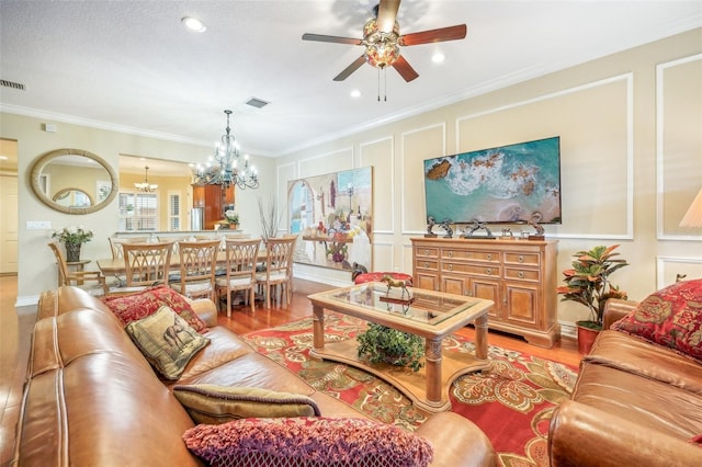 living room featuring a textured ceiling, ceiling fan with notable chandelier, crown molding, and hardwood / wood-style floors