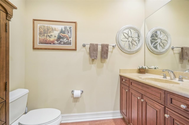 bathroom featuring vanity and toilet