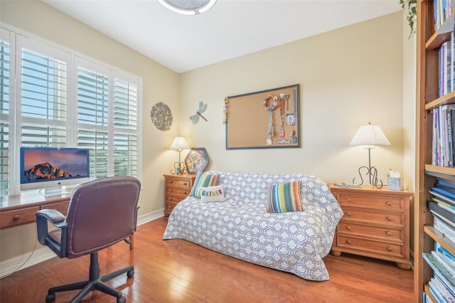 bedroom with hardwood / wood-style flooring