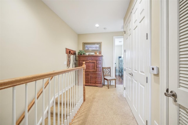 corridor featuring light colored carpet