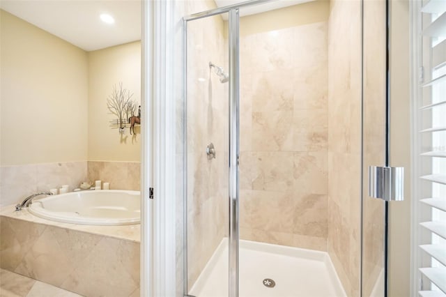 bathroom featuring separate shower and tub