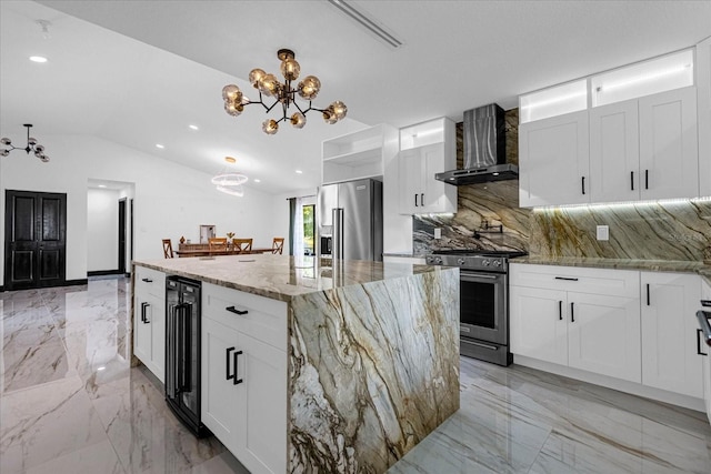 kitchen featuring light stone counters, stainless steel appliances, wall chimney range hood, a kitchen island, and tasteful backsplash