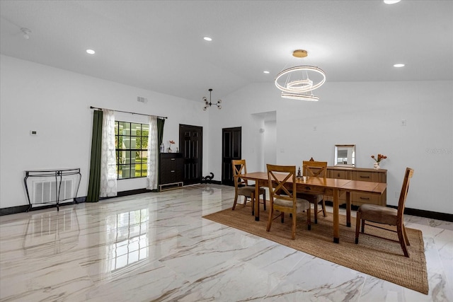 dining area with a notable chandelier and vaulted ceiling