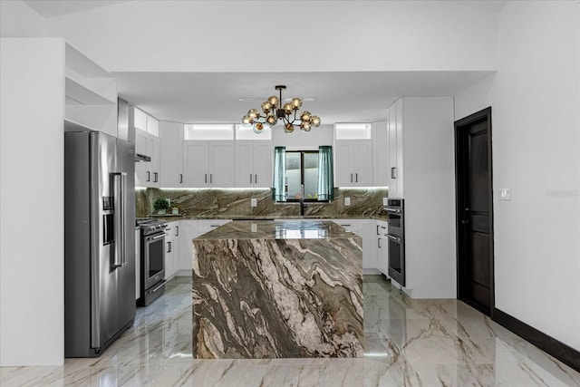 kitchen featuring appliances with stainless steel finishes, white cabinets, and decorative backsplash