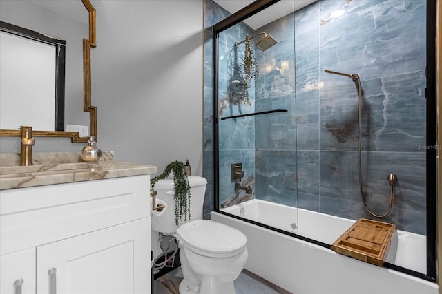 full bathroom featuring toilet, combined bath / shower with glass door, and vanity