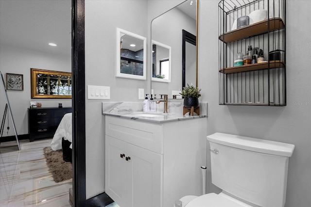 bathroom featuring vanity and toilet