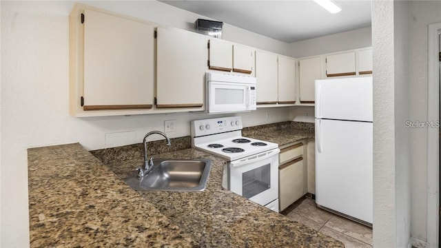 kitchen with sink, light tile patterned floors, white appliances, and white cabinets