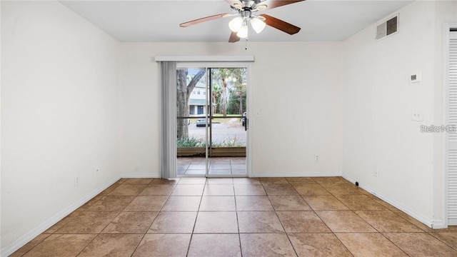 empty room featuring ceiling fan and light tile patterned flooring