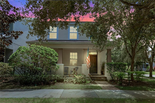 view of front of property featuring stucco siding and covered porch