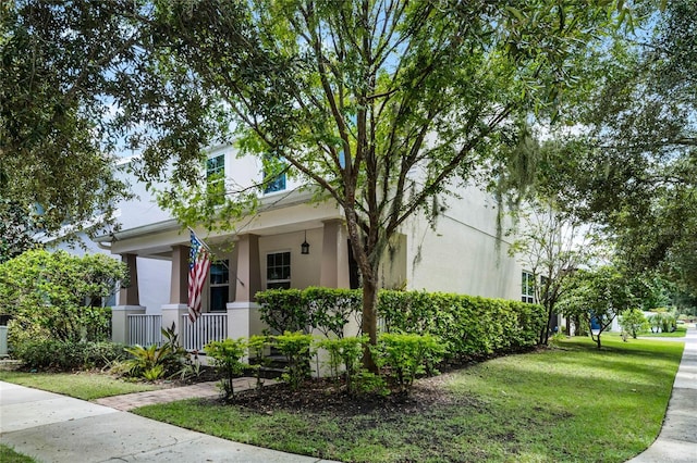 view of front facade featuring stucco siding and a front lawn