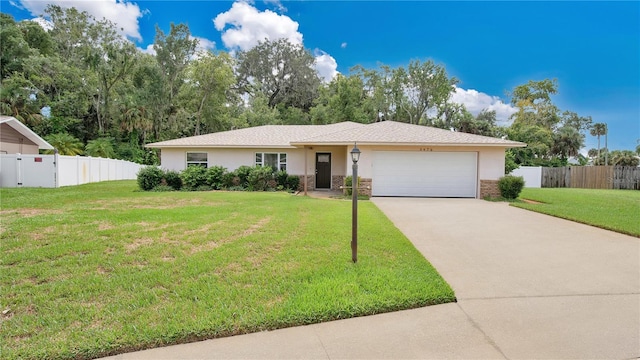 ranch-style house featuring a garage and a front lawn