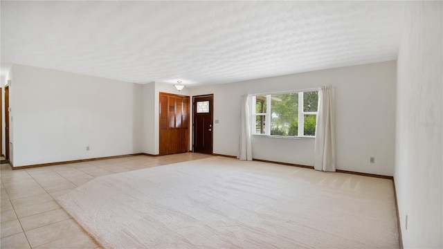 spare room with light tile patterned floors