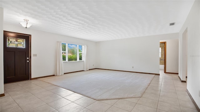 foyer featuring light tile patterned floors