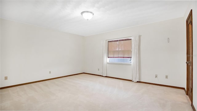 unfurnished room featuring light colored carpet