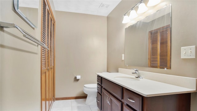 bathroom featuring toilet, vanity, and tile patterned floors