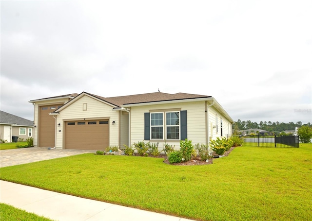 view of front of home featuring a front yard and a garage